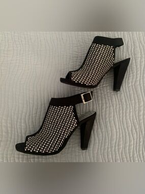 Black heels with silver stud detailing. Size 6.5.
